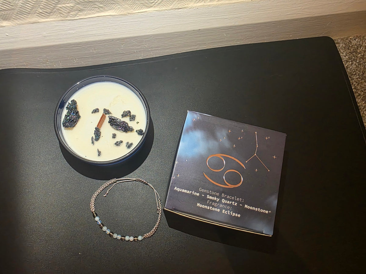 Cancer zodiac candle overhead view with bracelet and packaging