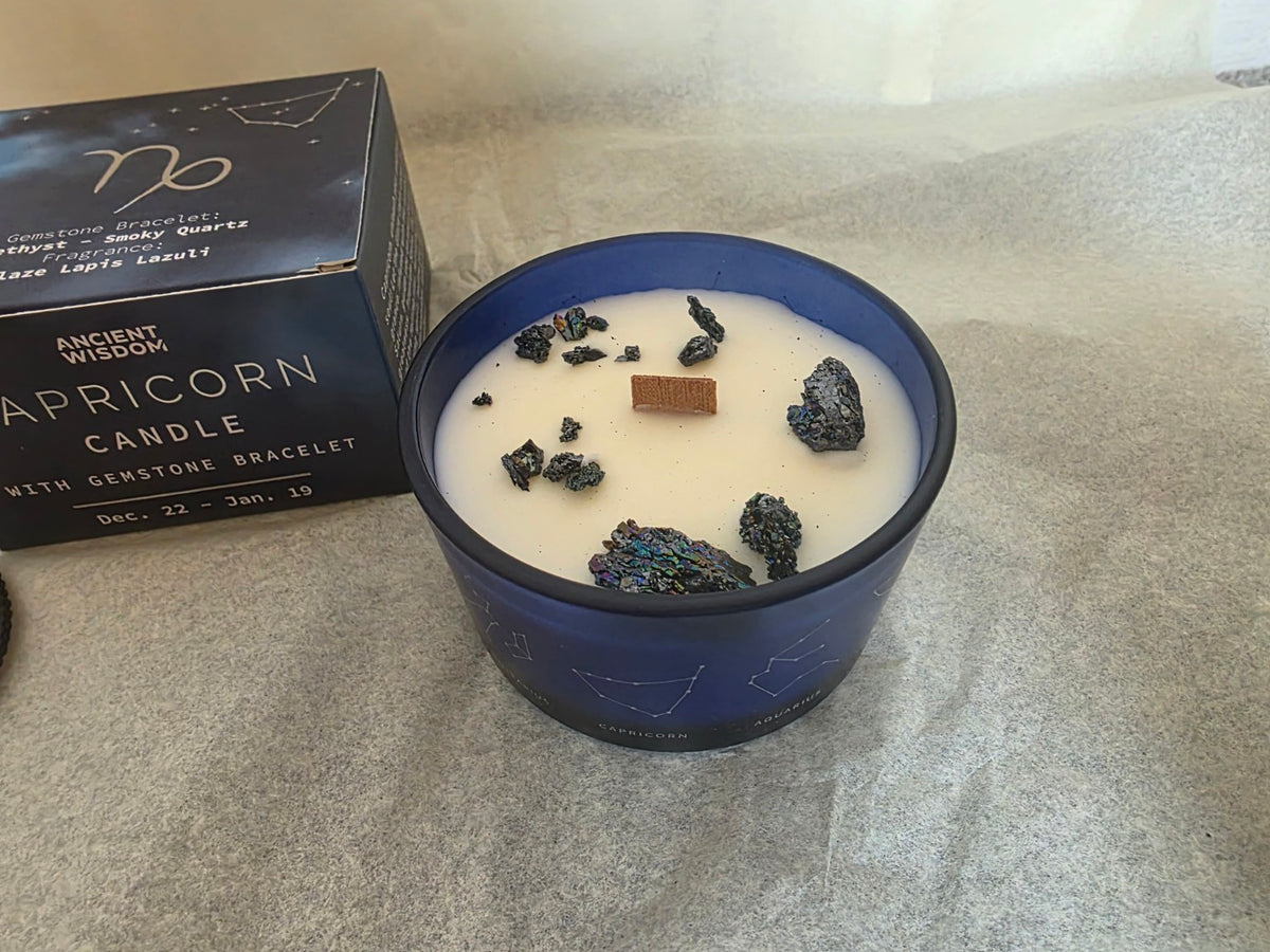 Capricorn zodiac candle close-up showing wooden wick and decorative gemstone pieces