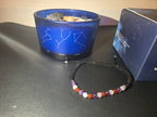 Virgo gemstone bracelet close-up with zodiac candle