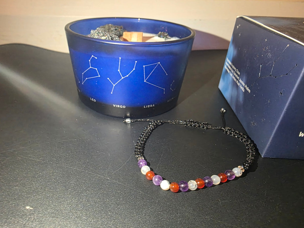 Virgo gemstone bracelet close-up with zodiac candle