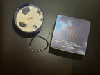 Virgo candle and box showing gemstone bracelet details and fragrance
